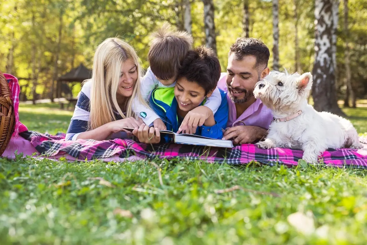 Family reading outdoors