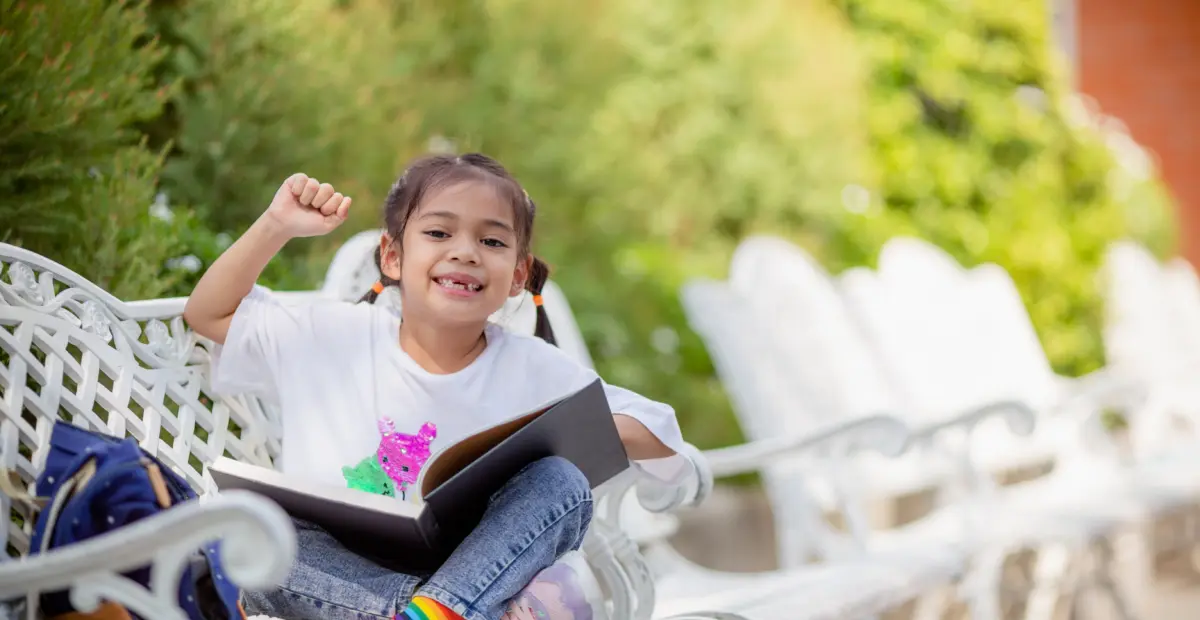 Back to school. Asian girl reading a book. Primary school students after classes learning homework.
