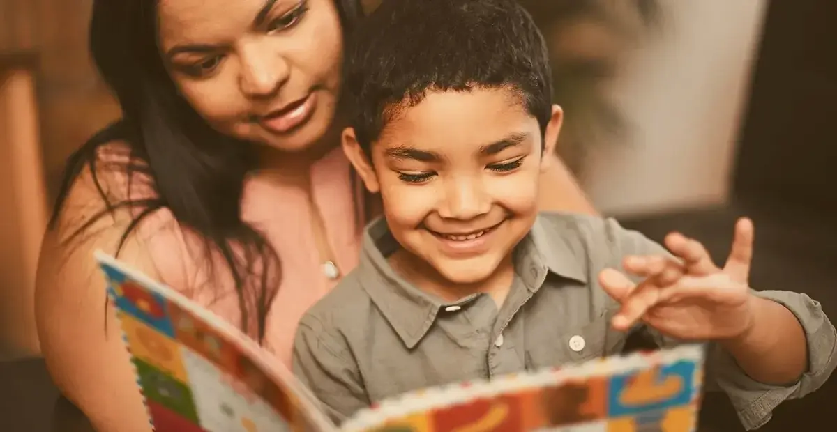 Latino Hispanic mother and child reading bilingual books Kids Read Now is supporting bilingual literacy