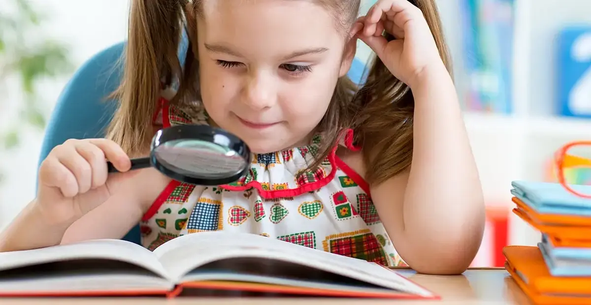 Magnifying glass girl with book