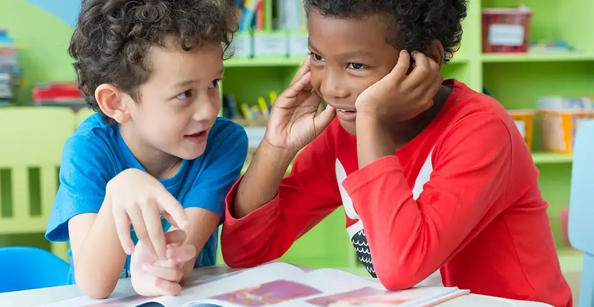 Two boys playing with a book
