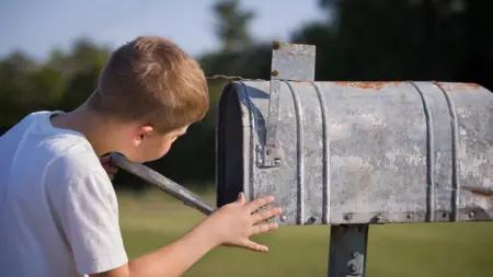 Bigstock A Cute Boy Checking The Mail 264696073