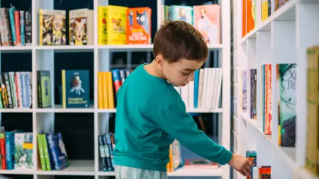 Boy reaching for book 4