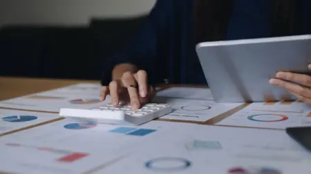 Close up businesswoman using calculator and laptop 2026 01 07 00 49 37 utc