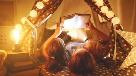 Parent reading with child before bed caregiver support Kids Read Now 2 scaled