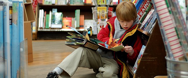 Child reading for pleasure in a book store