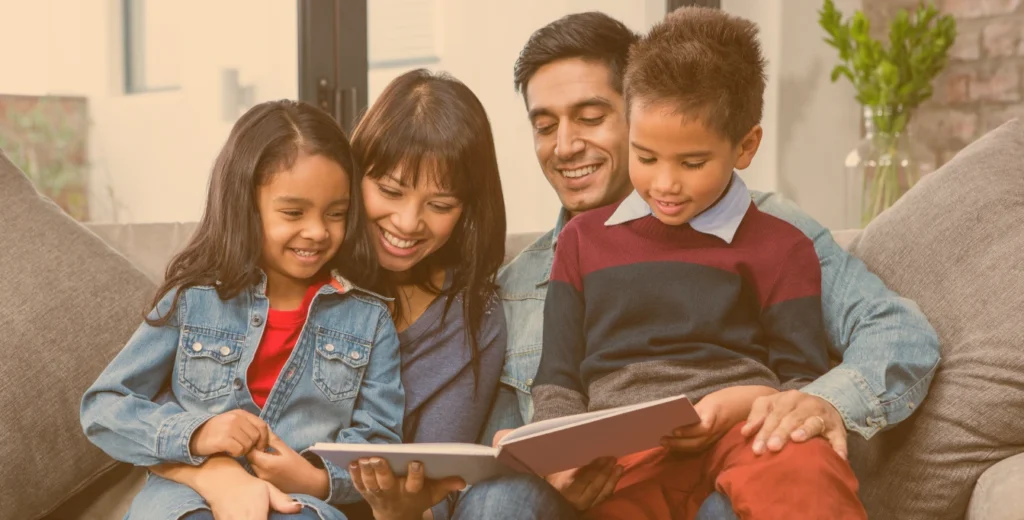 Latino/Hispanic family reading bilingual books; Kids Read Now is supporting bilingual literacy